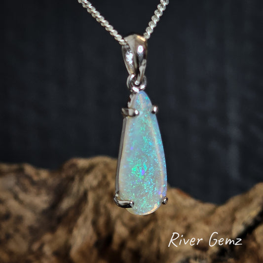 Light opal set in silver pendant on a dark background with 'River Gemz' branding.