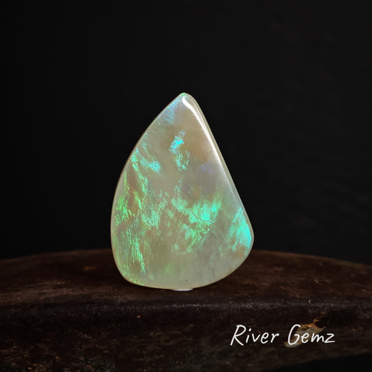A second image showing the front view of the solid white opal but with a black backdrop.