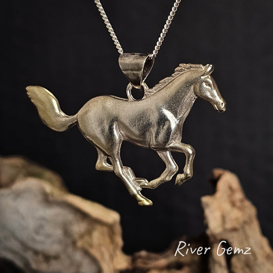 Silver horse pendant on a chain with a dark background.