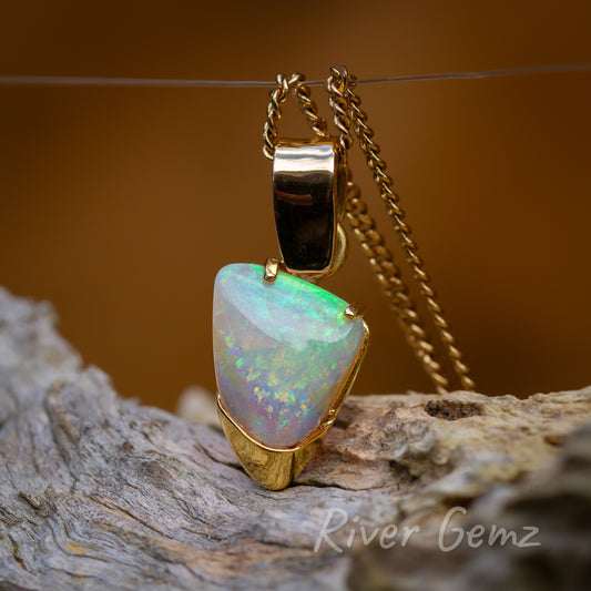 Unique setting with large bail and besel/claw hybrid showing off the stunning free-form cut opal.