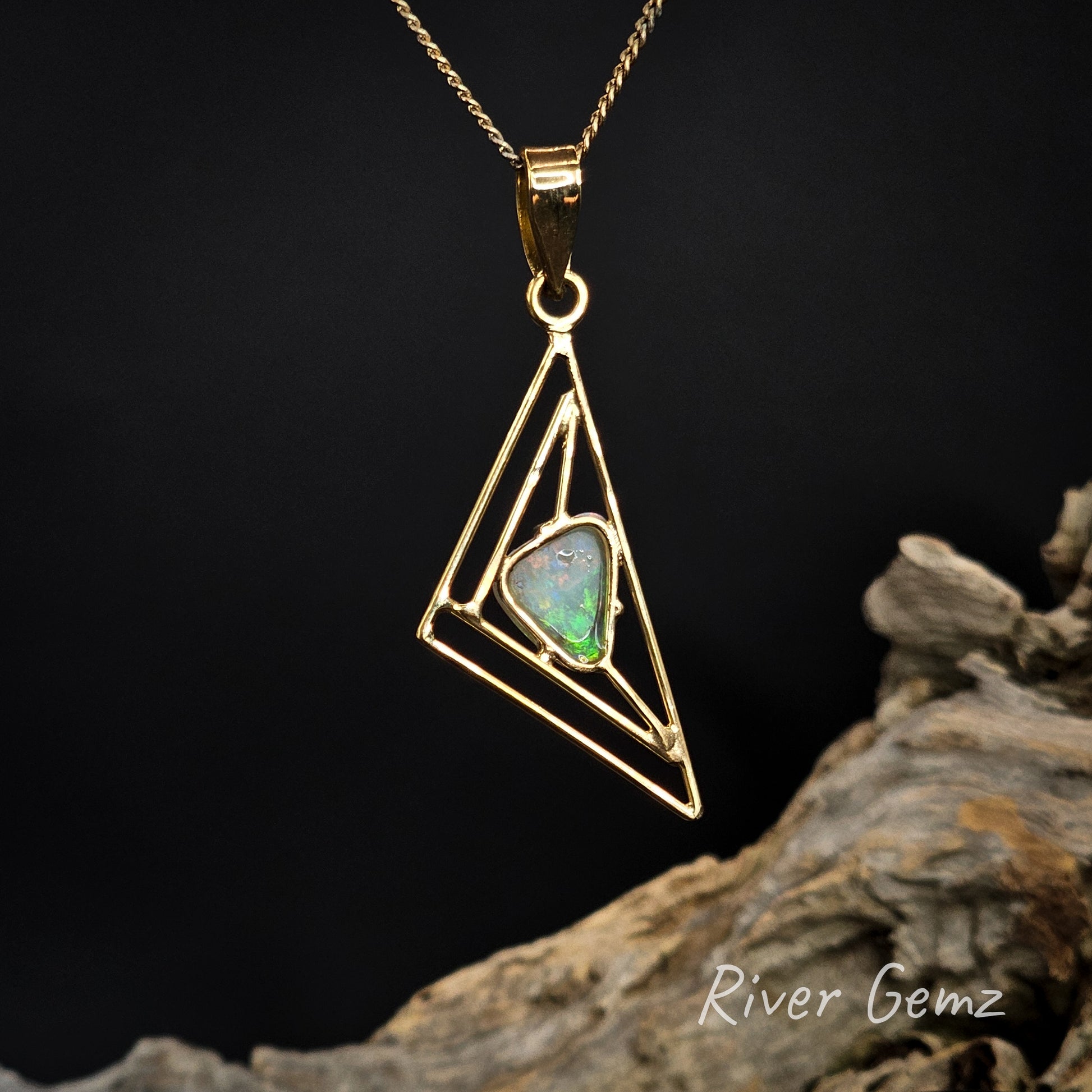 Rear view of gold pendant shows the light base tone of the crystal opal.