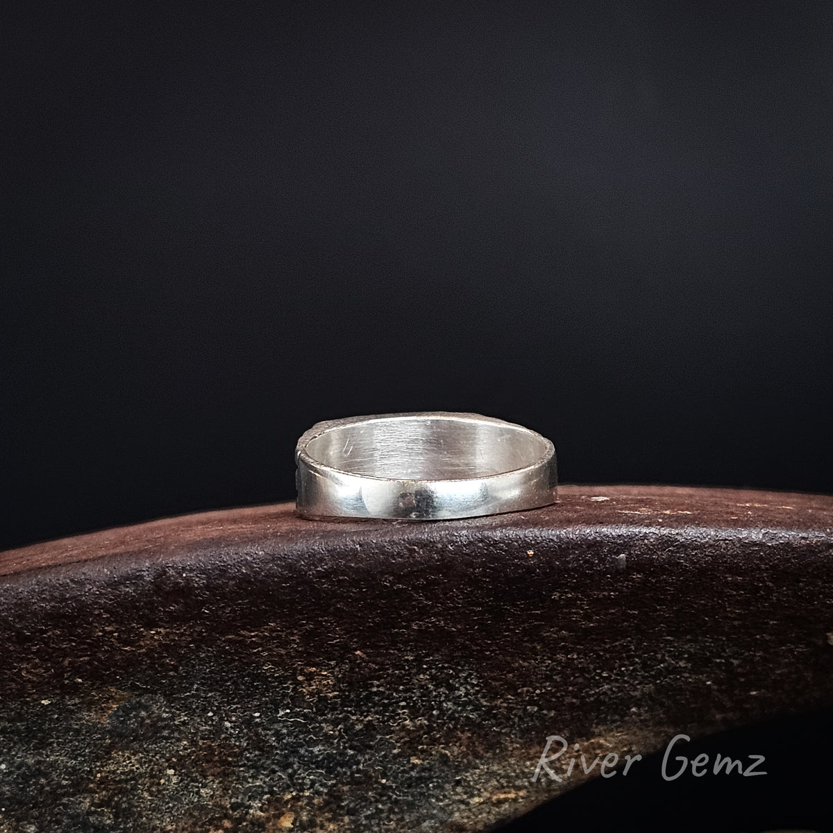 Rear view of ring shows the smooth silver interior with the full silver backing behind the opal inlaid in it.