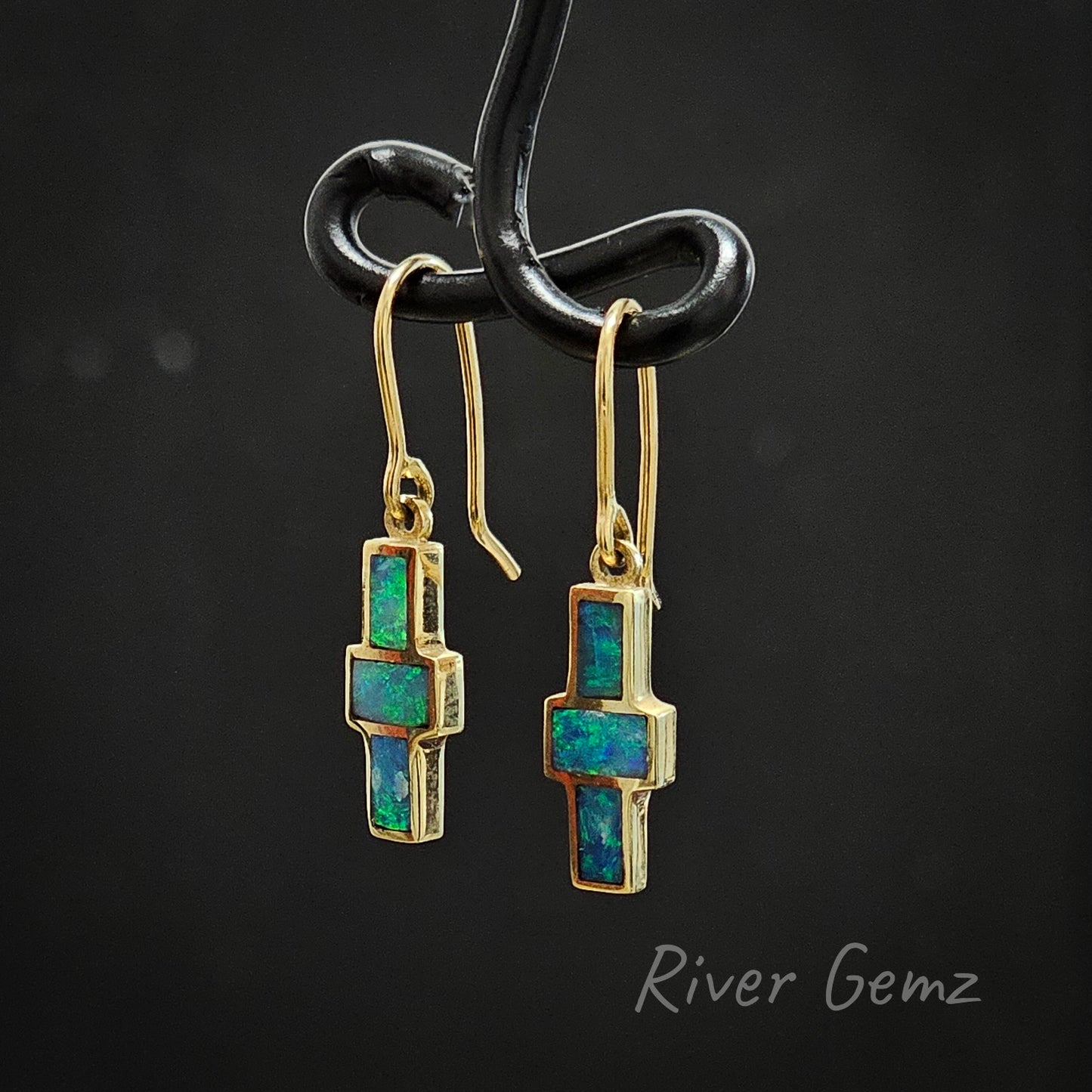 Long hooks are shown in this pair of opal earrings.