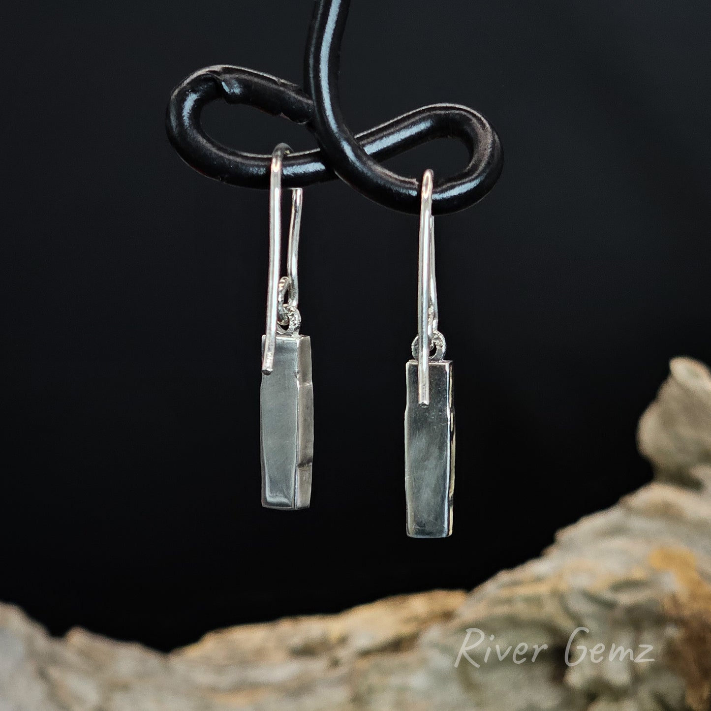 Back of earrings shows the silver backing behind the opals.