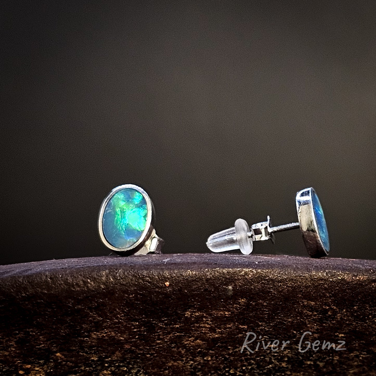Opal stud earrings on a dark background with 'River Gemz' branding.