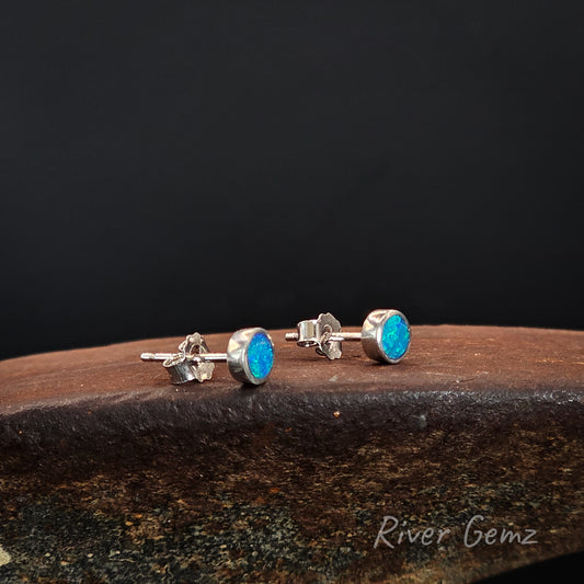 Pair of round faced stud earrings with blue and green opals.