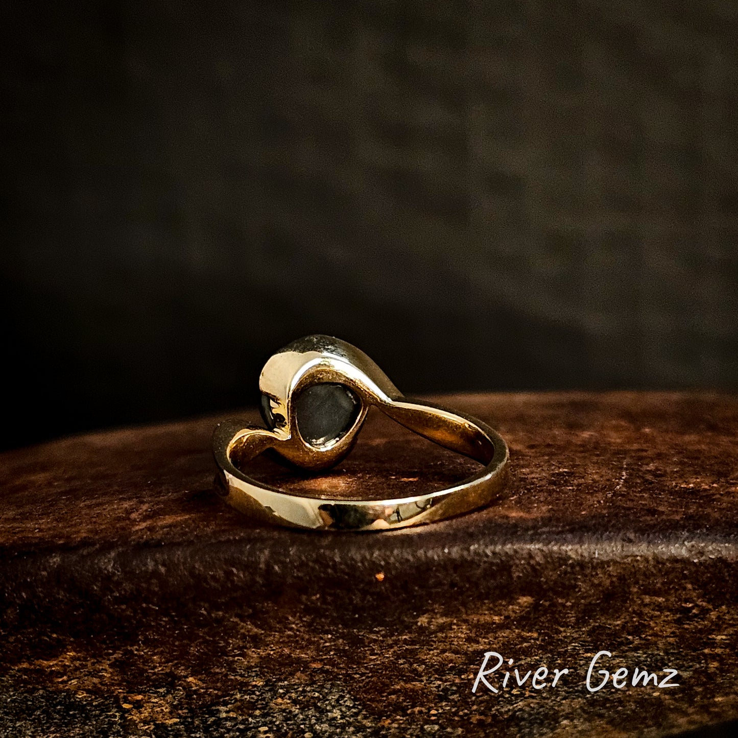 Back of ring shows the dark tone of the included black opal.