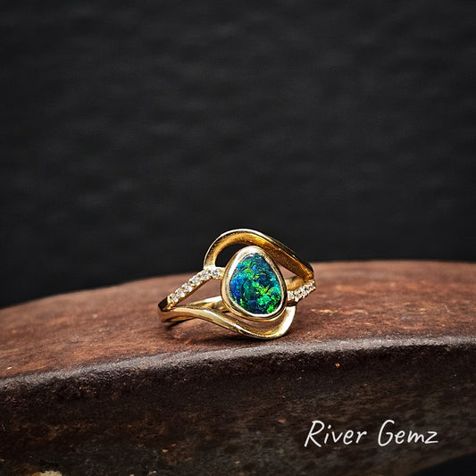 Opal and multi-diamond ring in yellow gold.