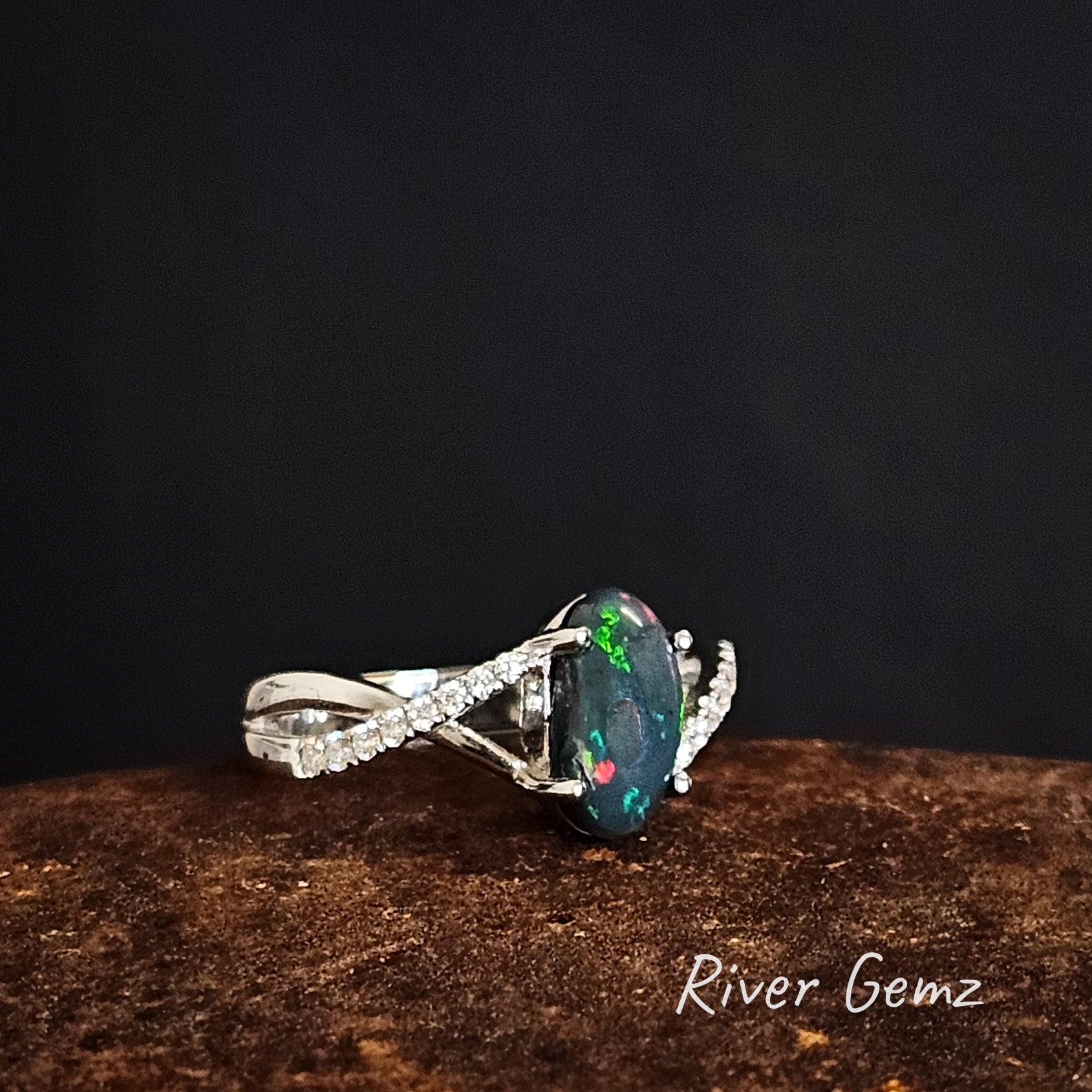 Green and red flashes in the black opal.