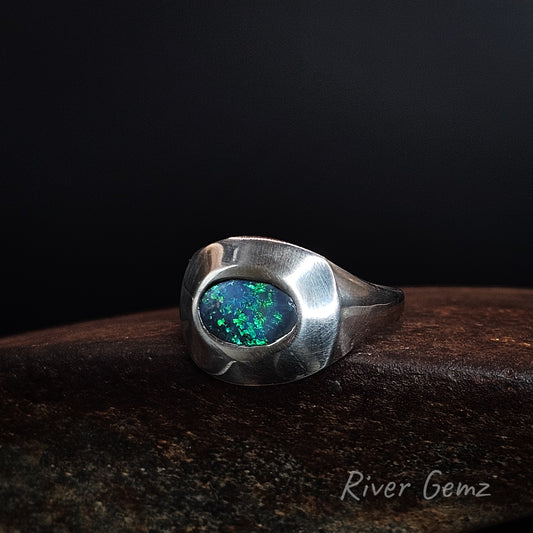 Oval shaped dark opal set East-West in sterling silver ring.