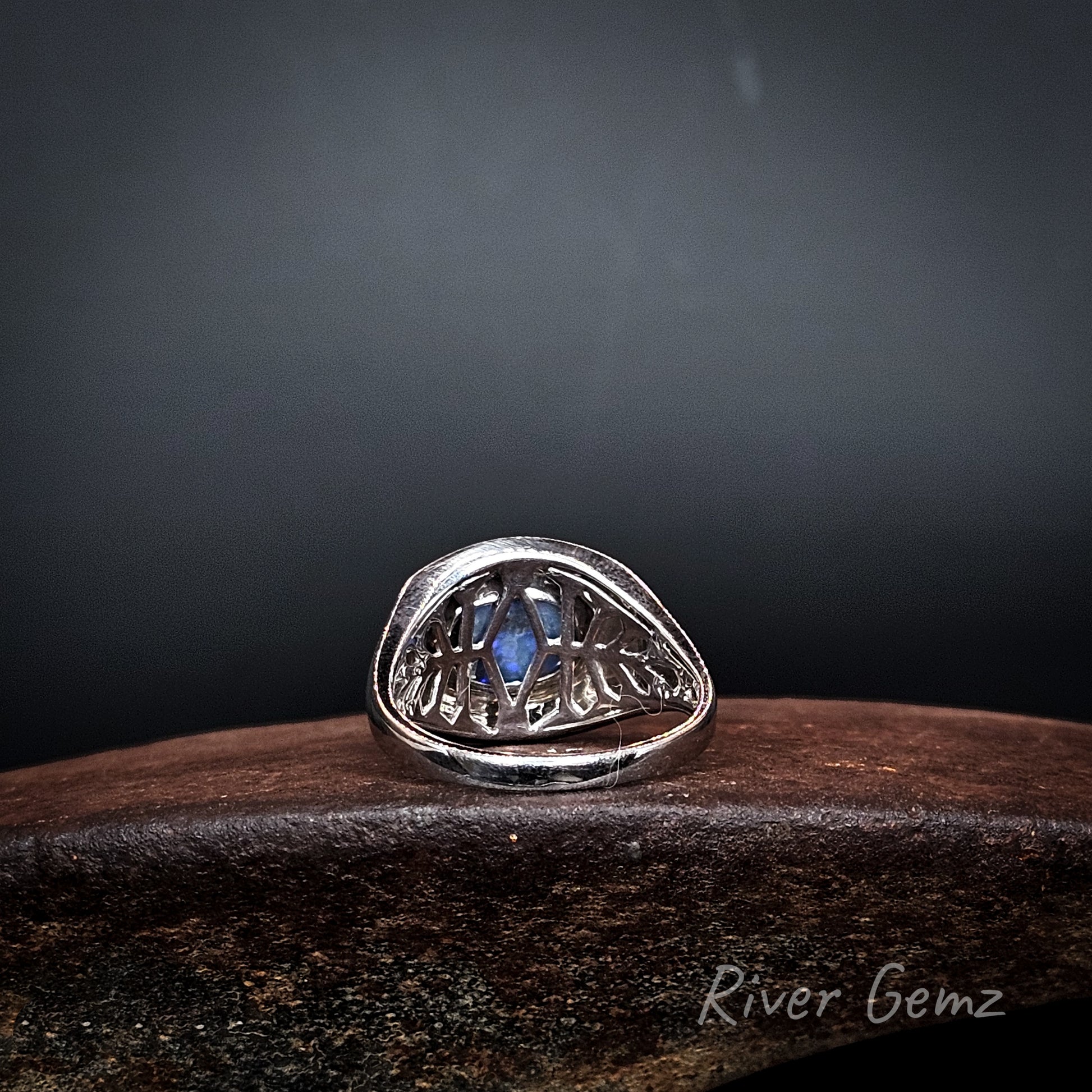 Rear view shows the silver lattice work behind the opal in the silver ring.