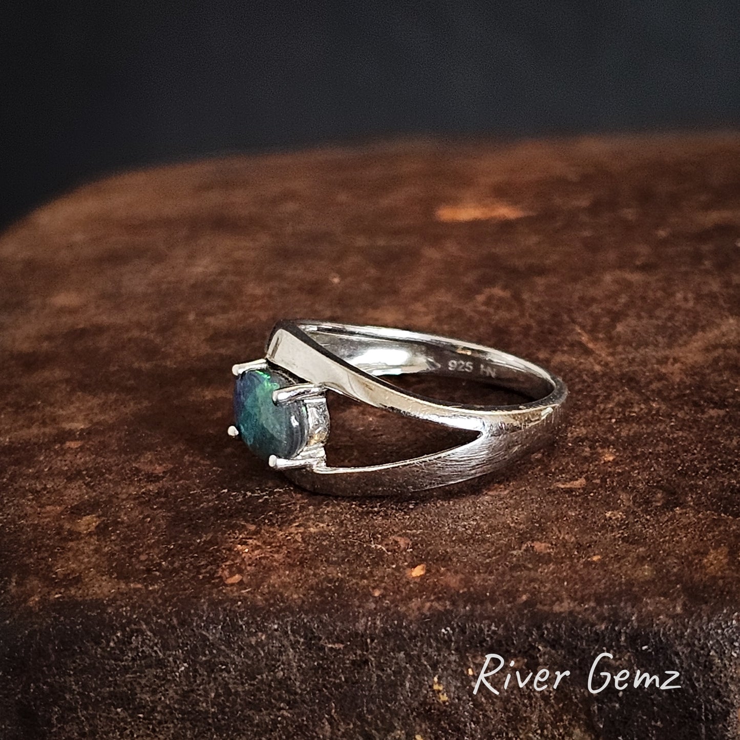 Side view of the black opal ring shows the 925 stamp for sterling silver.