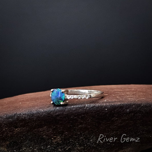 Round blue and green dark opal and white topaz stones in sterling silver ring.