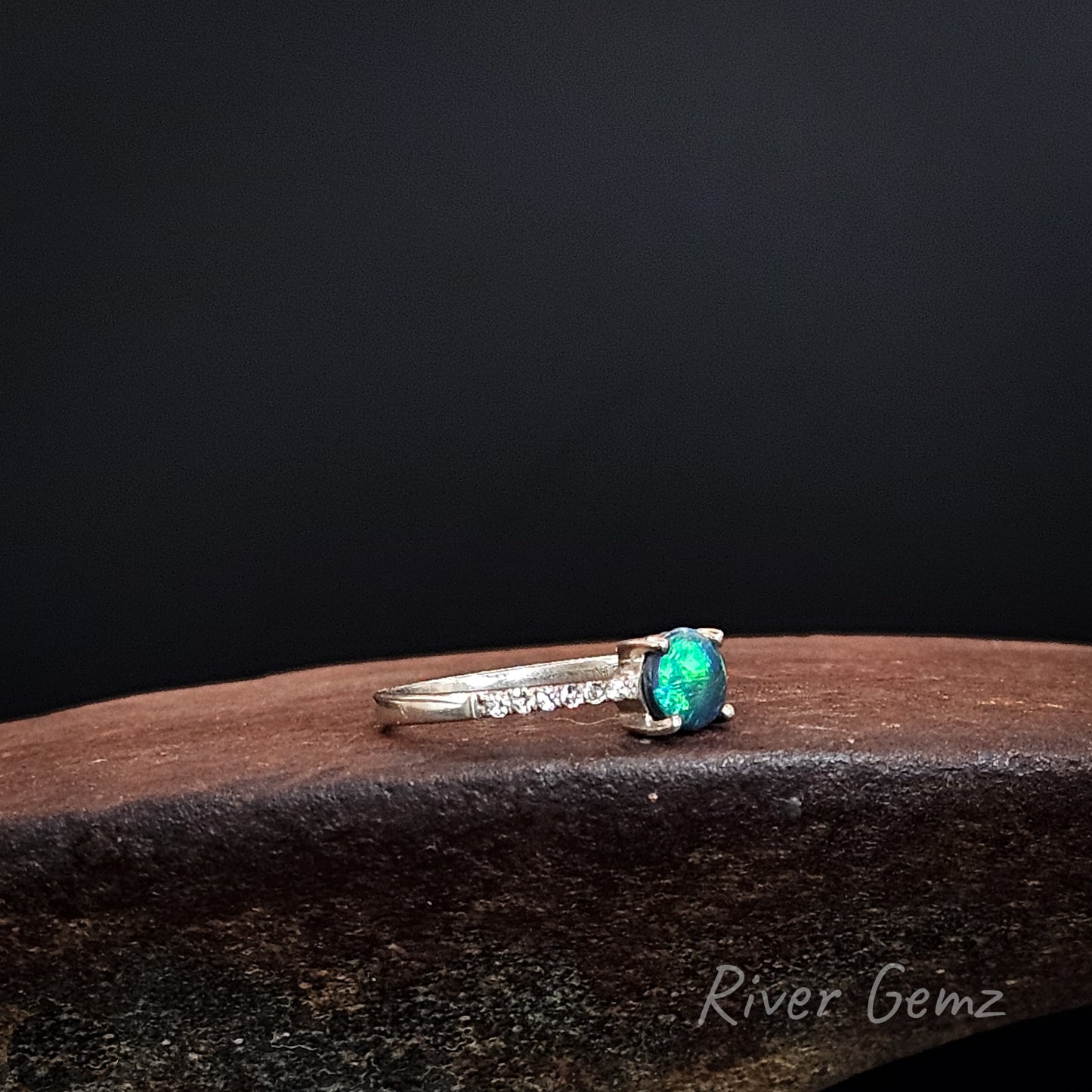 Bright green round opal claw set in sterling silver ring.