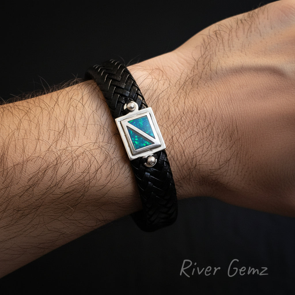 Black braided leather bracelet with a silver and blue gemstone shown on a person's wrist.