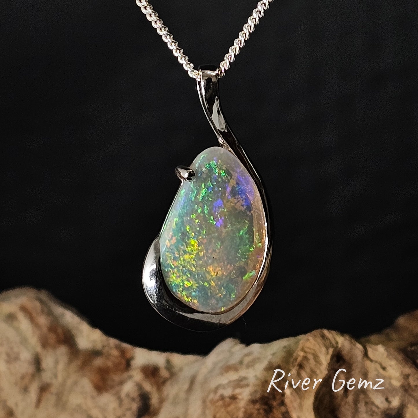 Light opal pendant in sterling silver necklace on a dark background with 'River Gemz' branding.