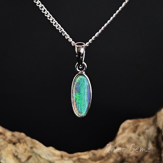Opal pendant necklace on a chain with a dark background and 'River Gemz' branding.
