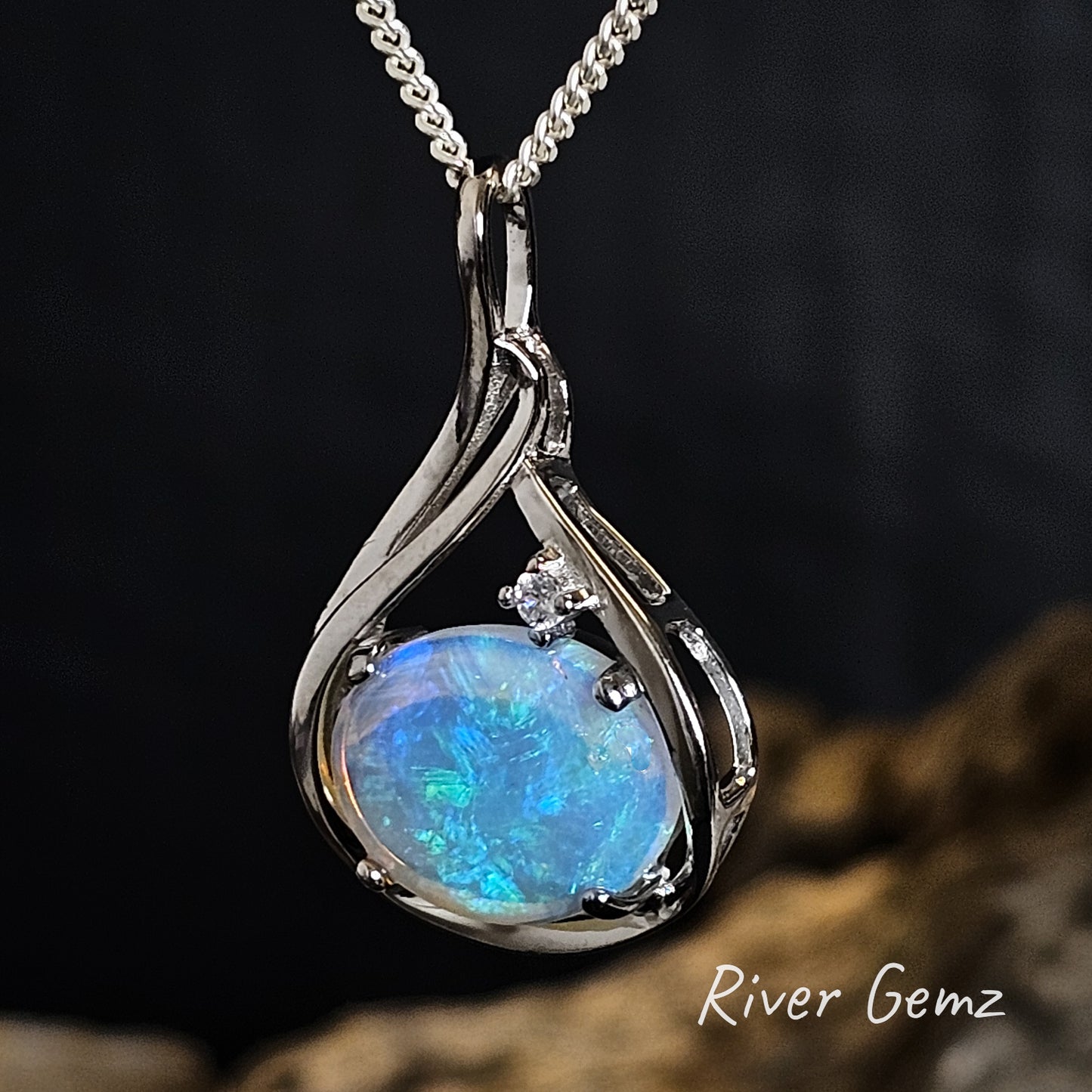 Opal pendant necklace with a dark background.