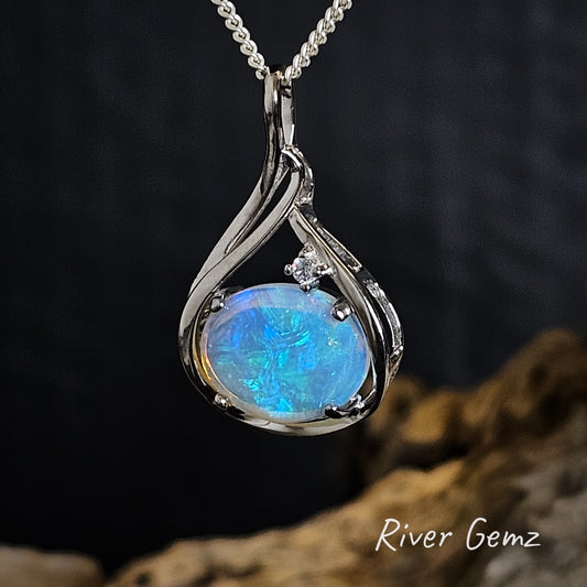 Light blue coloured crystal opal and white topaz stone necklace with silver setting on a dark background, featuring 'River Gemz' branding.