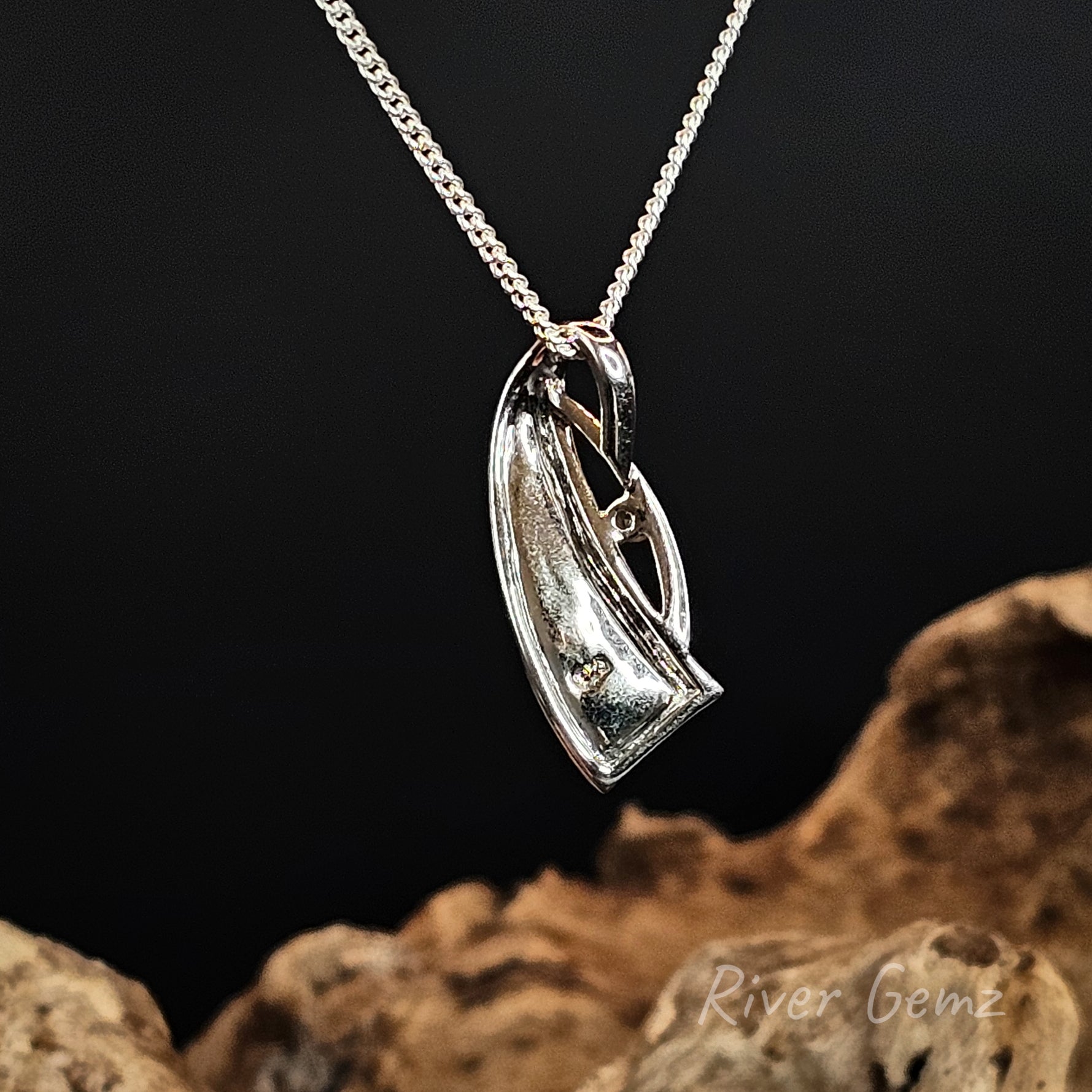 Rear view of the pendant shows the silver backing behind the 4 inlayed opals on a dark background with 'River Gemz' branding.