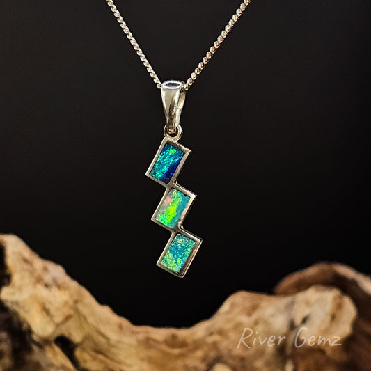 Opal pendant necklace on a dark background with 'River Gemz' branding.