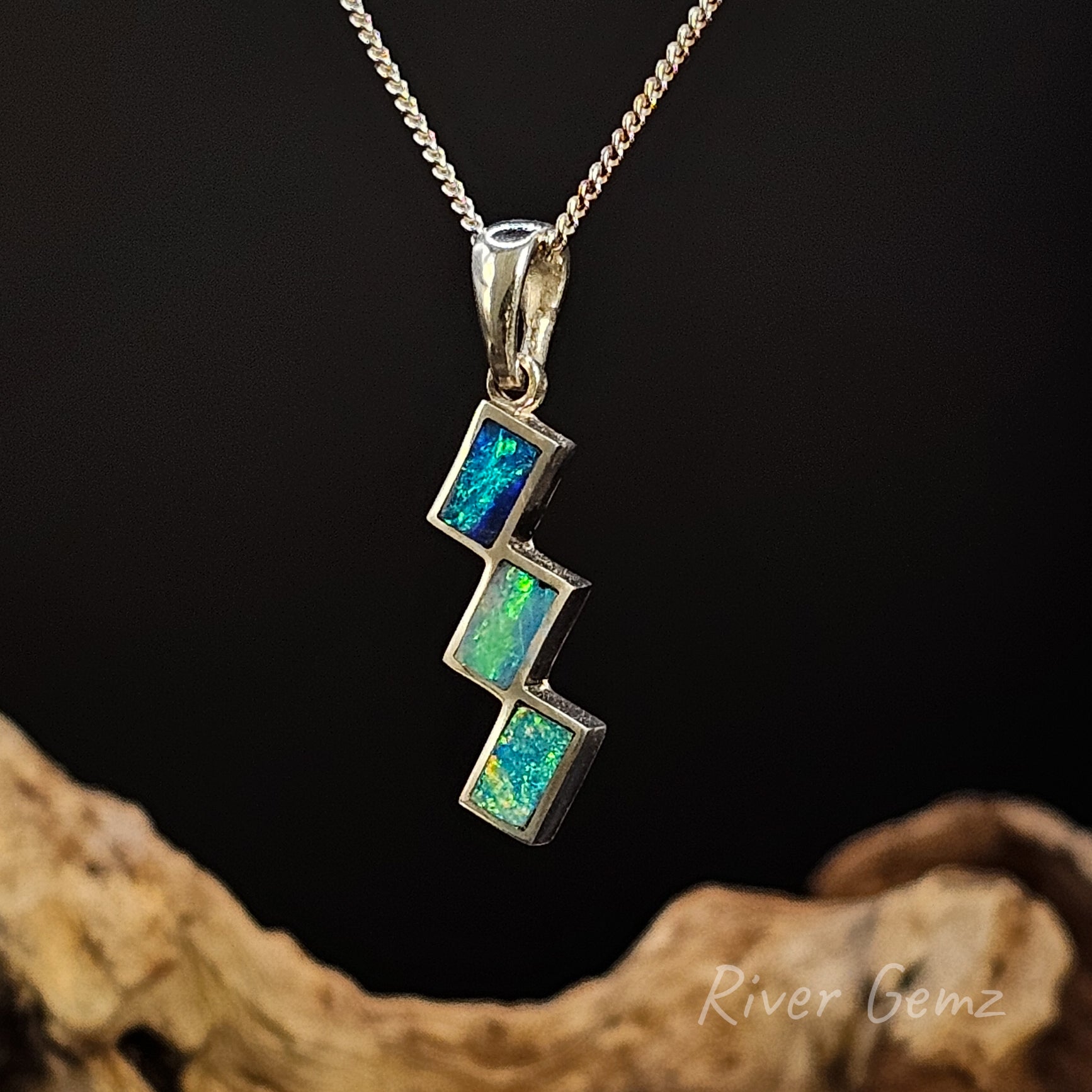 Tri-opal pendant set in sterling silver with a dark background and 'River Gemz' branding.