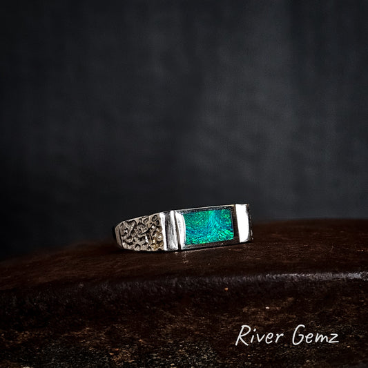 Silver ring with rectangular shaped green crystal opal on a dark background, featuring 'River Gemz' branding.