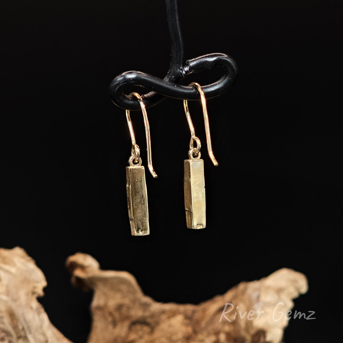 Rear view of yellow gold hook earrings showing the gold backing used behind the opals set in them.