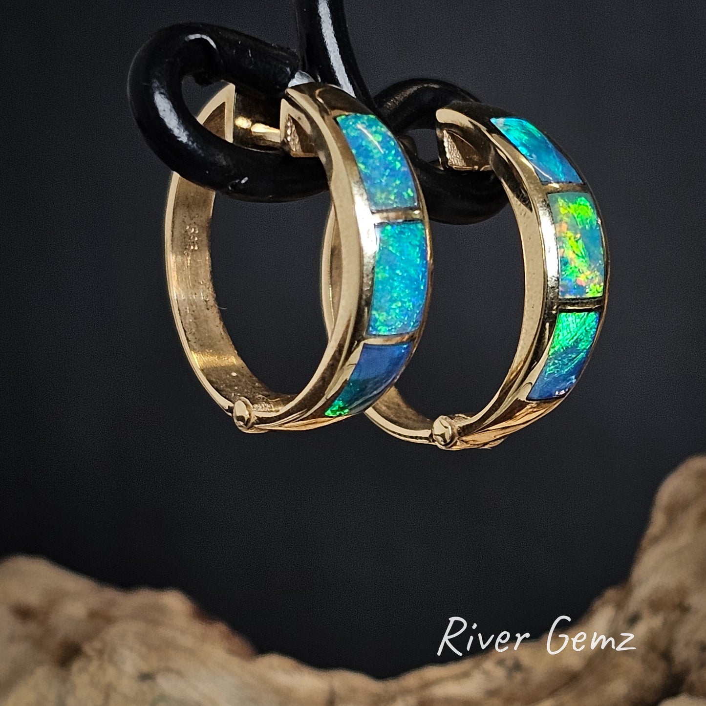 Opal huggies with gold trim on a dark background, branded 'River Gemz'.