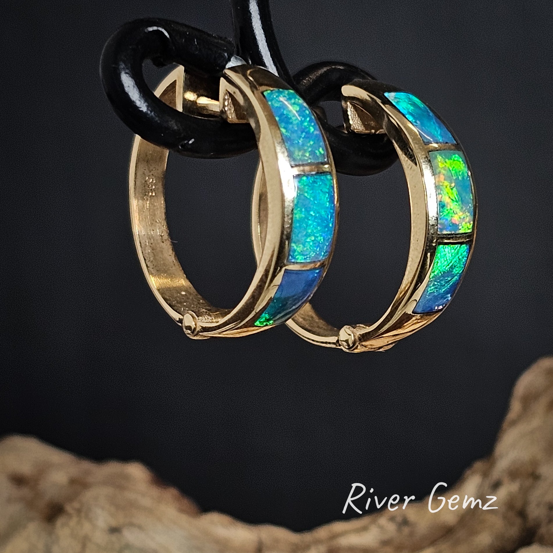 Opal huggies with gold trim on a dark background, branded 'River Gemz'.