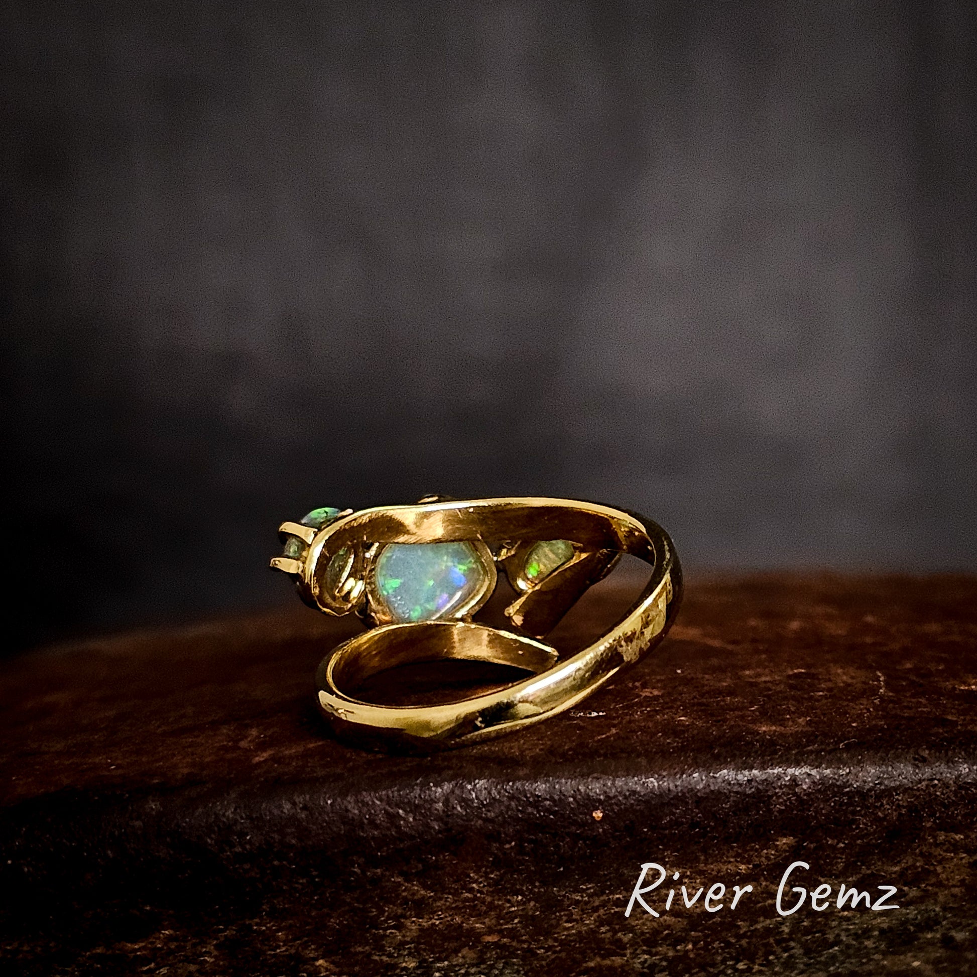 Back of ring showing the light tone base of the included crystal opals.