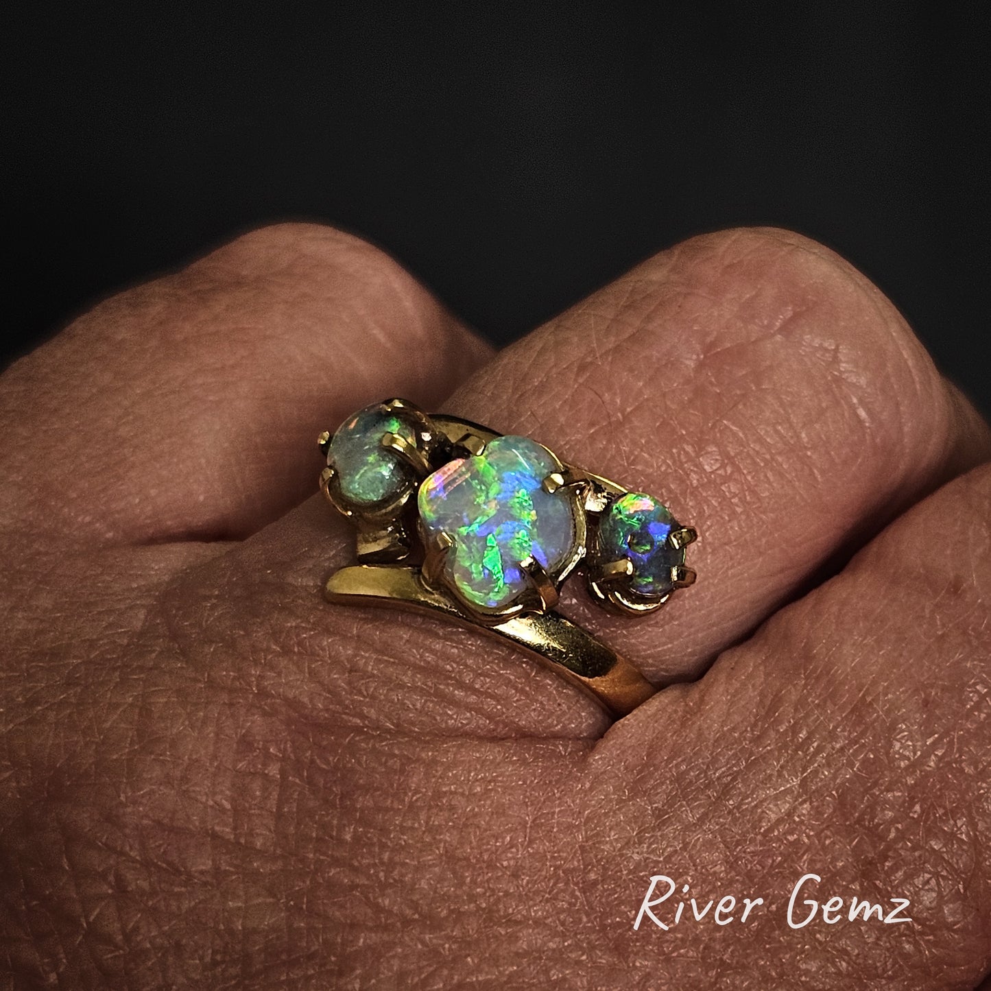 Opal and gold ring worn on left hand ring finger.