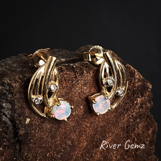 Yellow gold stud earrings with round crystal opals and diamonds.