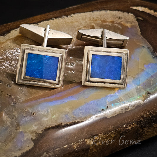 Rectangular shaped ocean blue opals inlayed into silver cufflinks.