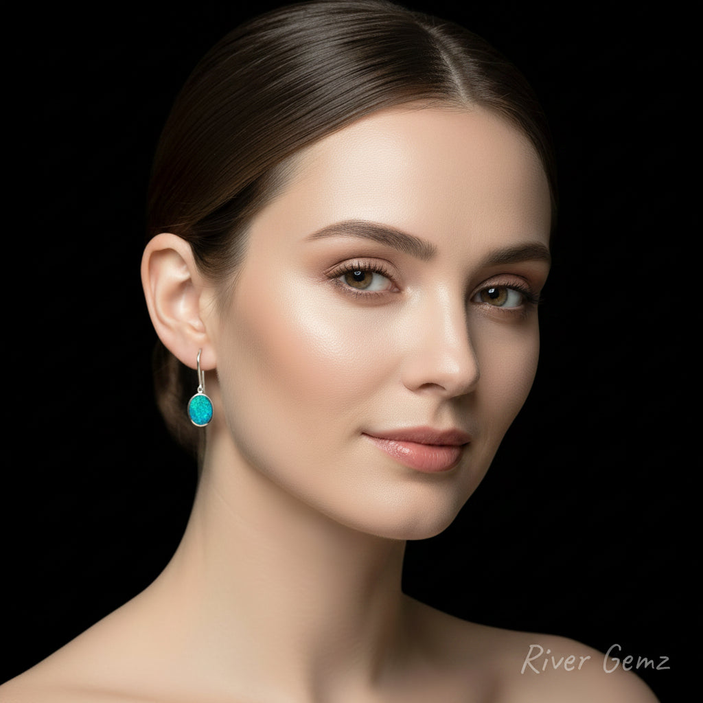 Crystal opals with blue and green swirls of colour set in silver earrings. 