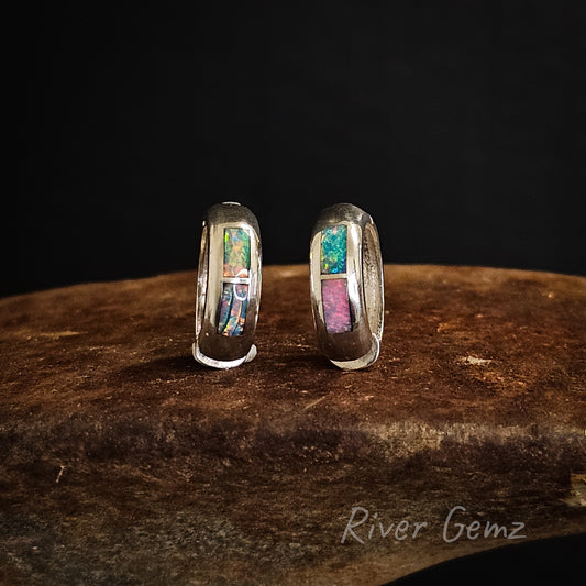 Pair of silver huggie earrings with 2 rectangular opals embedded.