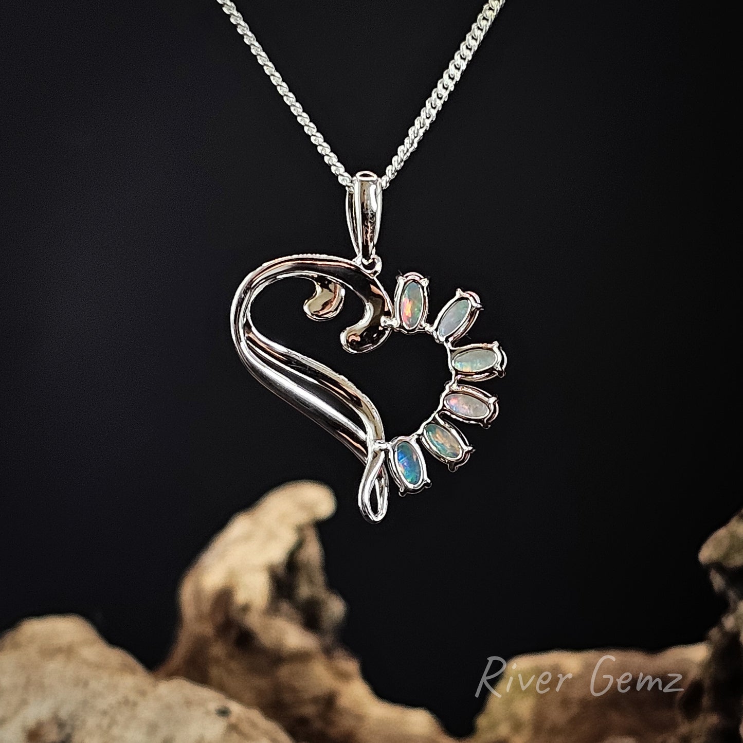 Rear view of sterling silver pendant shows the light base tone of the crystal opals in the necklace.