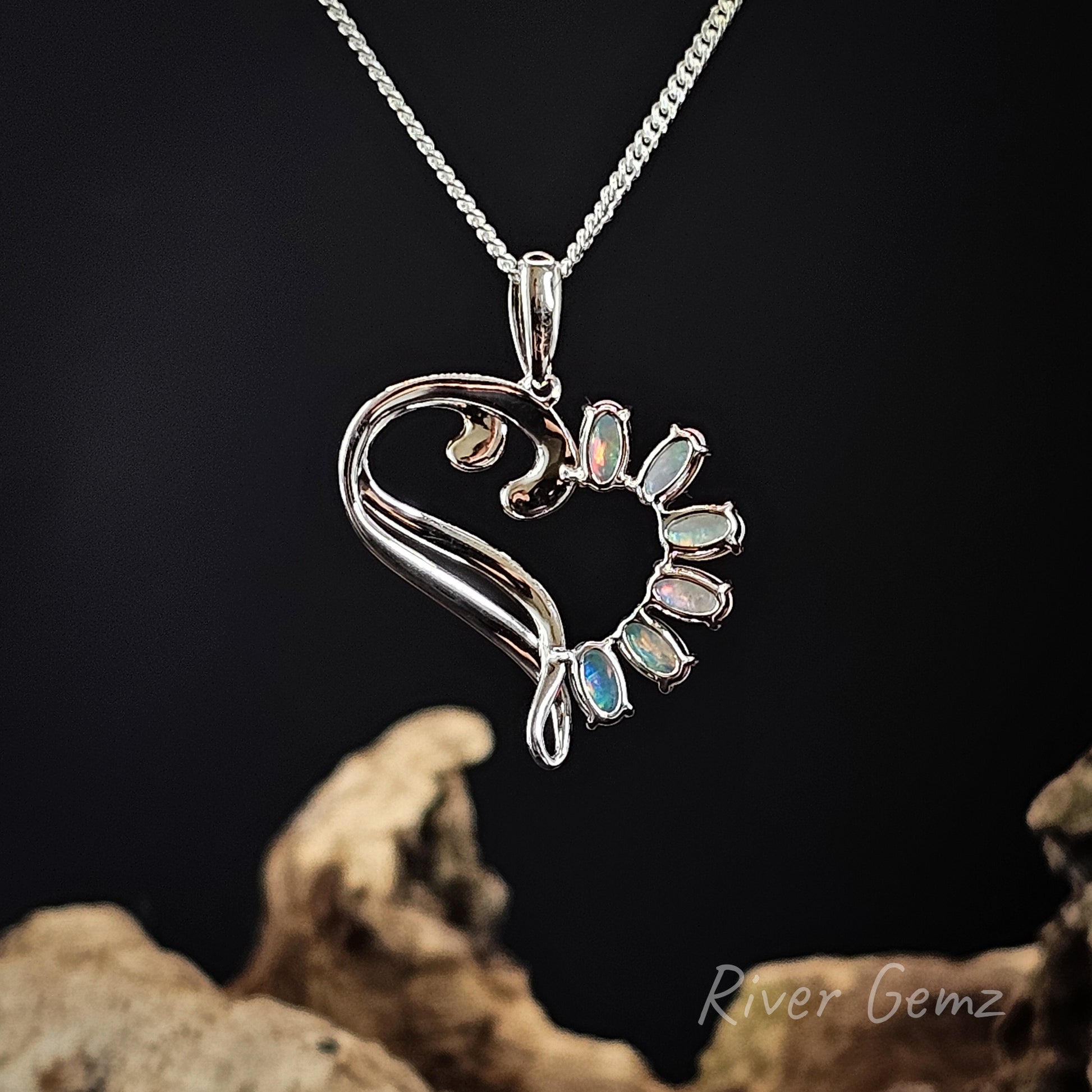 Rear view of sterling silver pendant shows the light base tone of the crystal opals in the necklace.