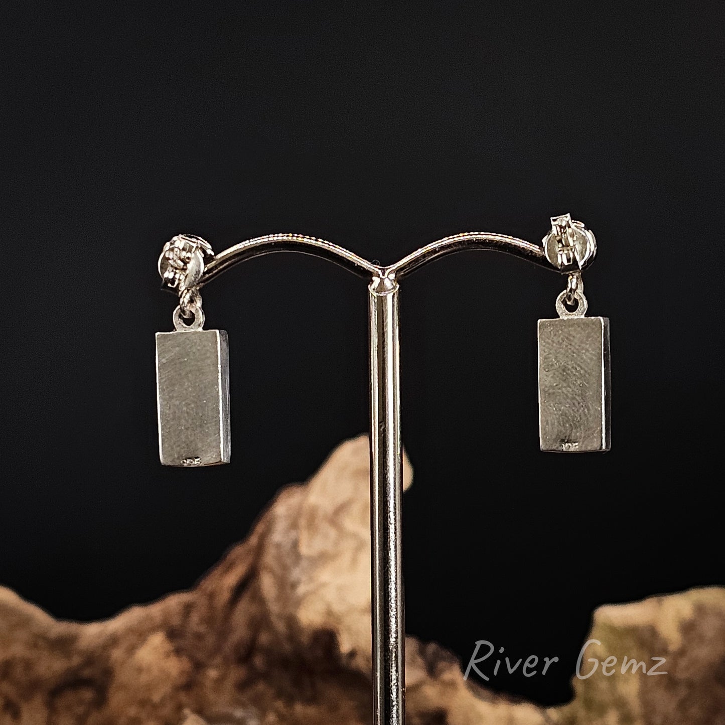 Rear view of the earrings show the full silver backing behind the opals.