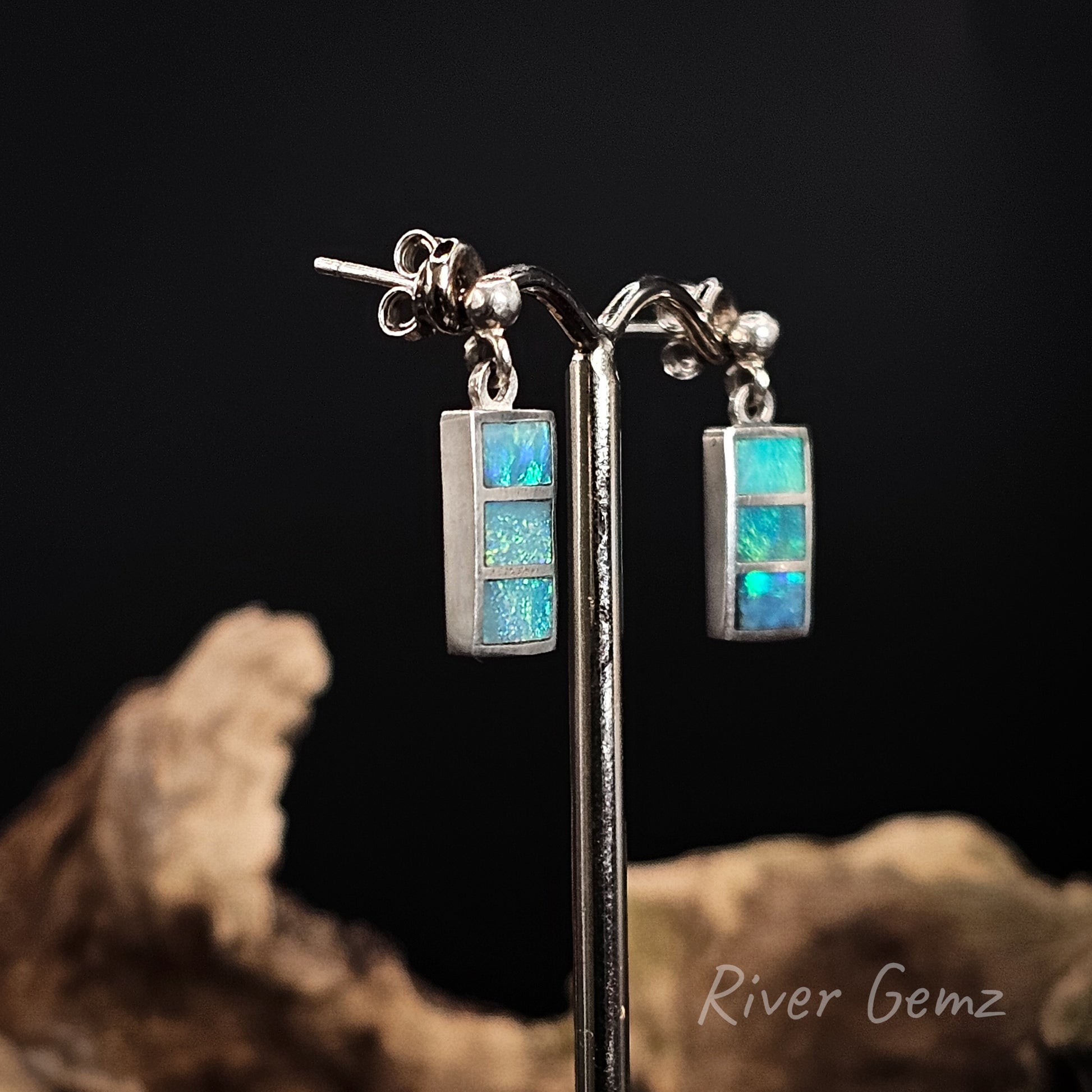 Stud earrings with 3 opals set in silver.