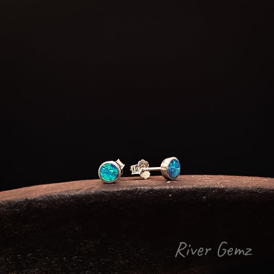 Silver earrings with turquoise gemstones on a dark background, branded 'River Gemz'.
