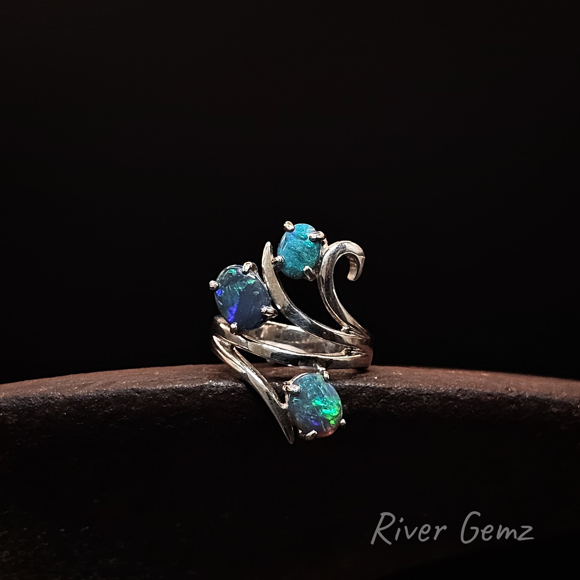 Blue and green dark opals set in sterling silver ring.
