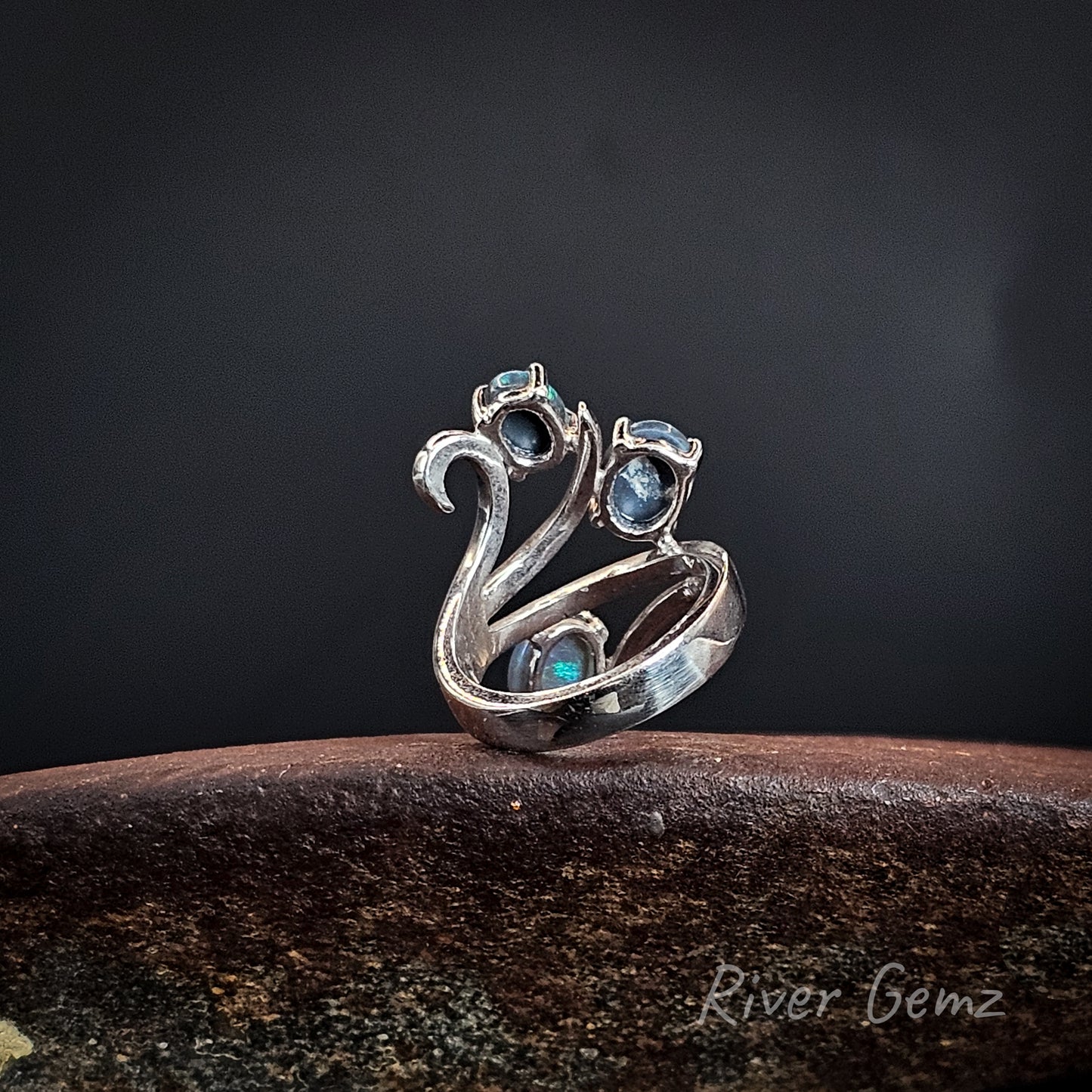 Rear view of the ring shows the dark base tone of the 3 semi-black opals set in it.