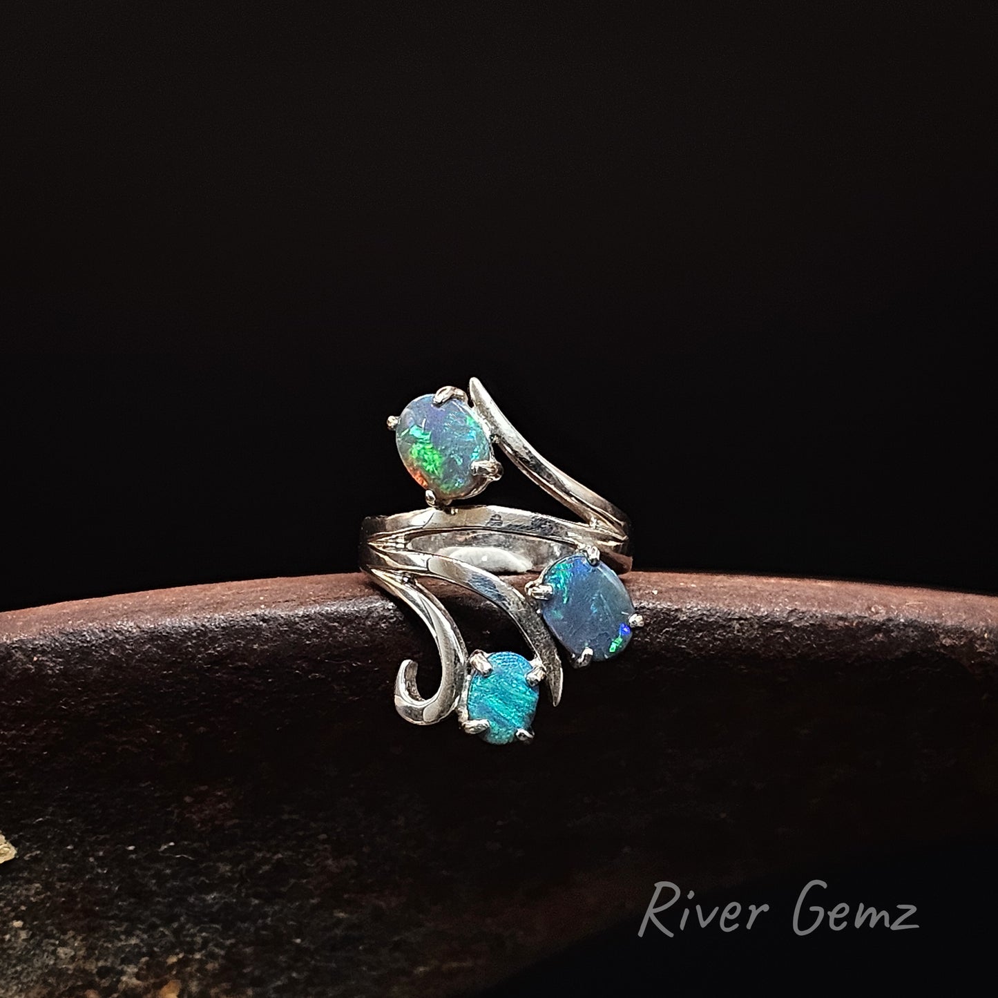 Three opals claw set in sterling silver ring.