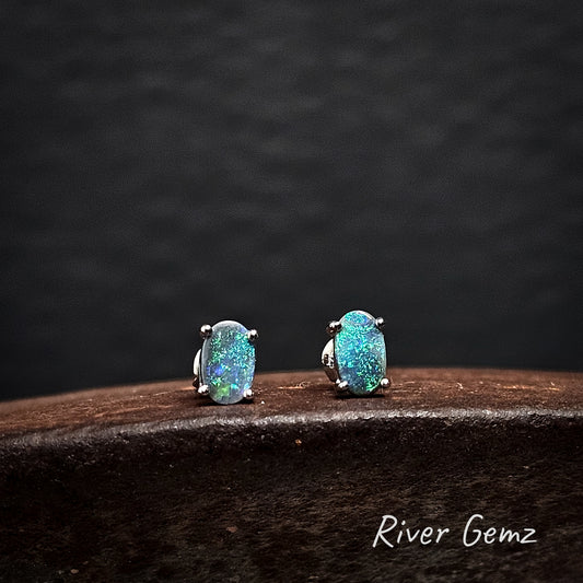 Pair of turquoise opal earrings on a dark background with 'River Gemz' branding.