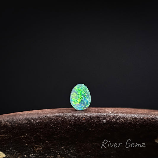 Opal stone on a dark background with 'River Gemz' branding.