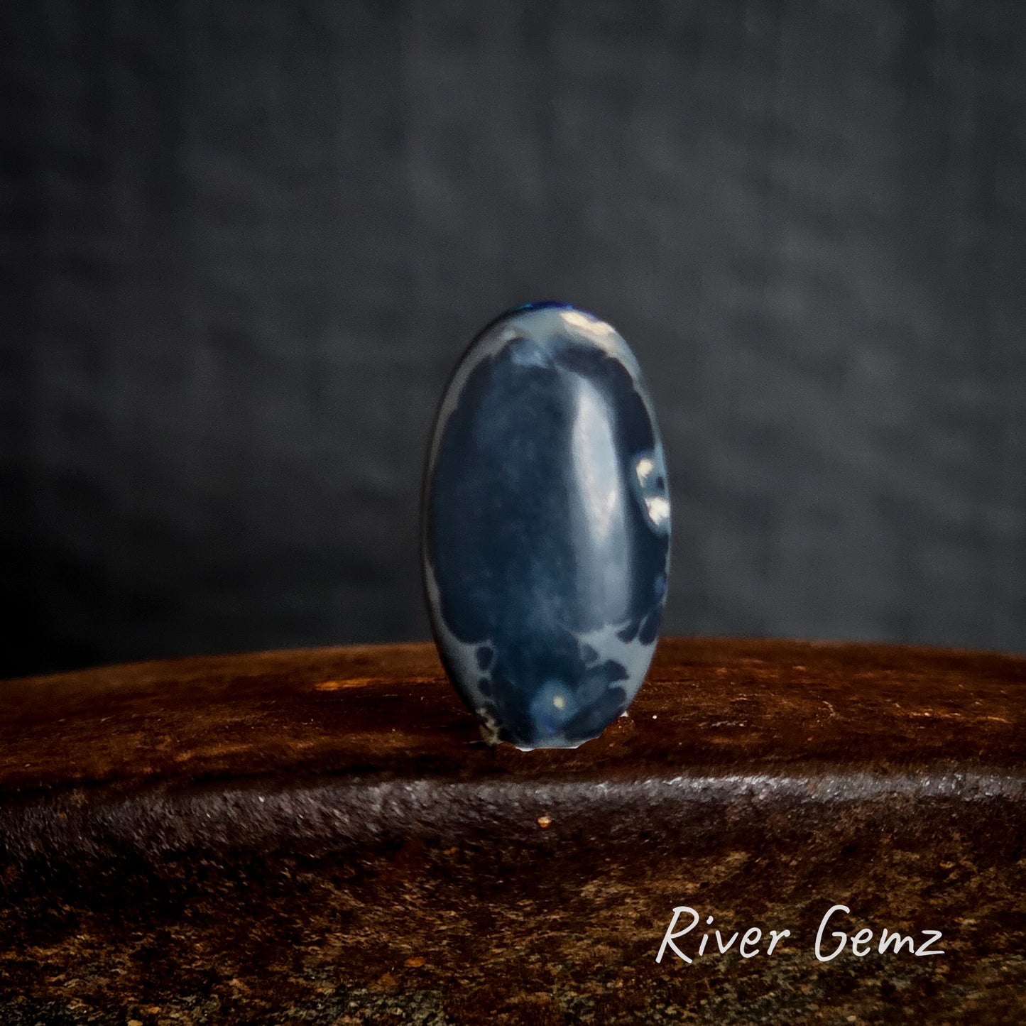 Back of stone showing the dark tone of the black opal.