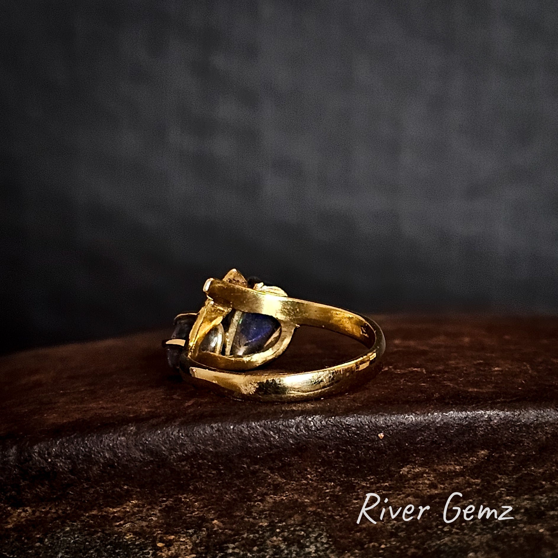 Rear view of the ring shows the dark base tone of the black opal.