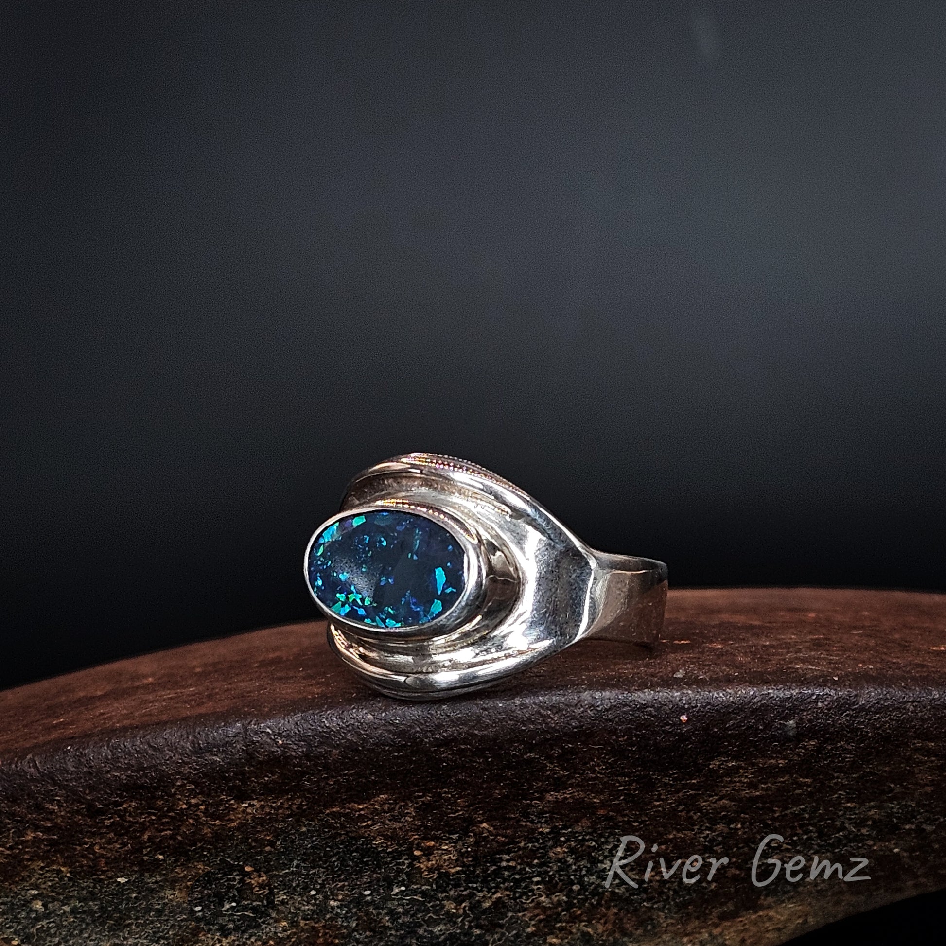 Blue and green black opal set in silver ring.