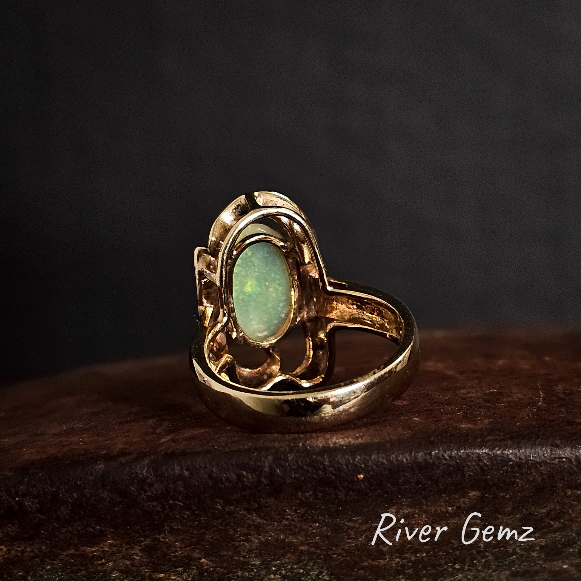 Back view of the gold ring shows the light base tone of the light opal set within it.